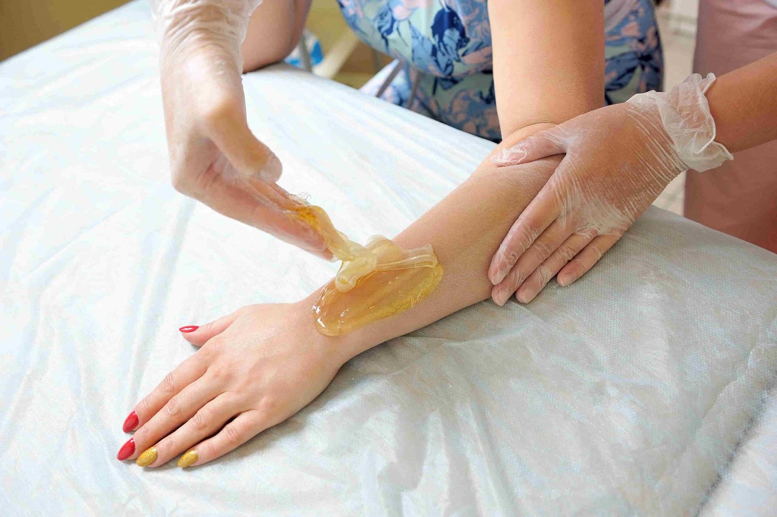 Sugaring treatment on arms for smooth skin.