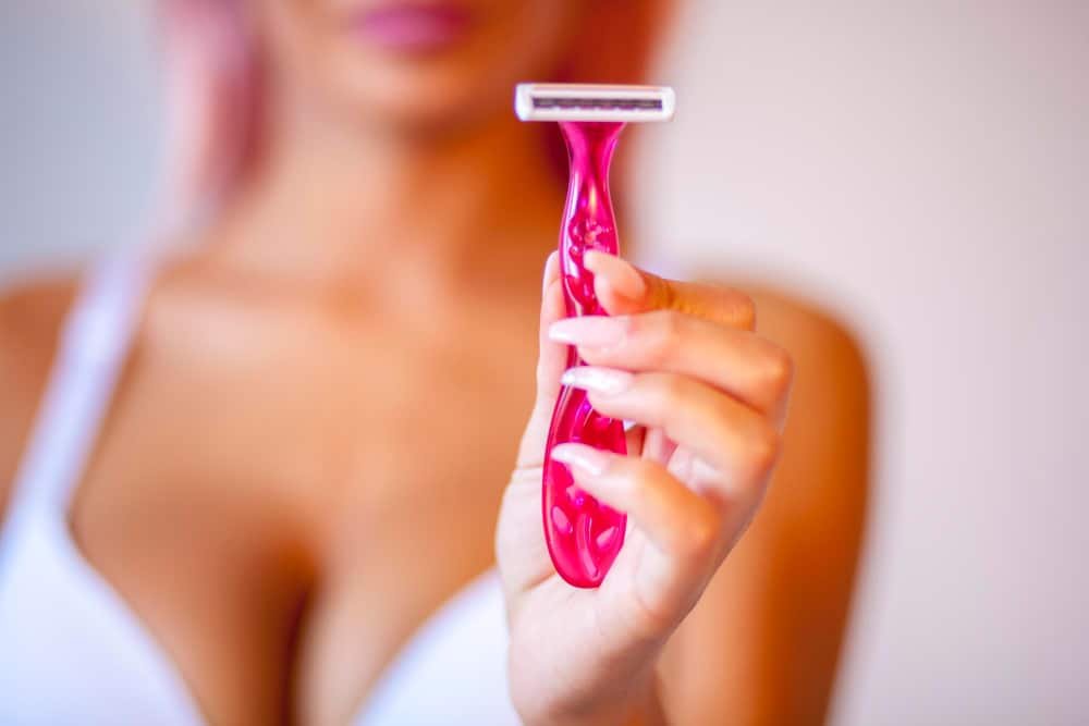 Woman applying hair removal bikini area cream.