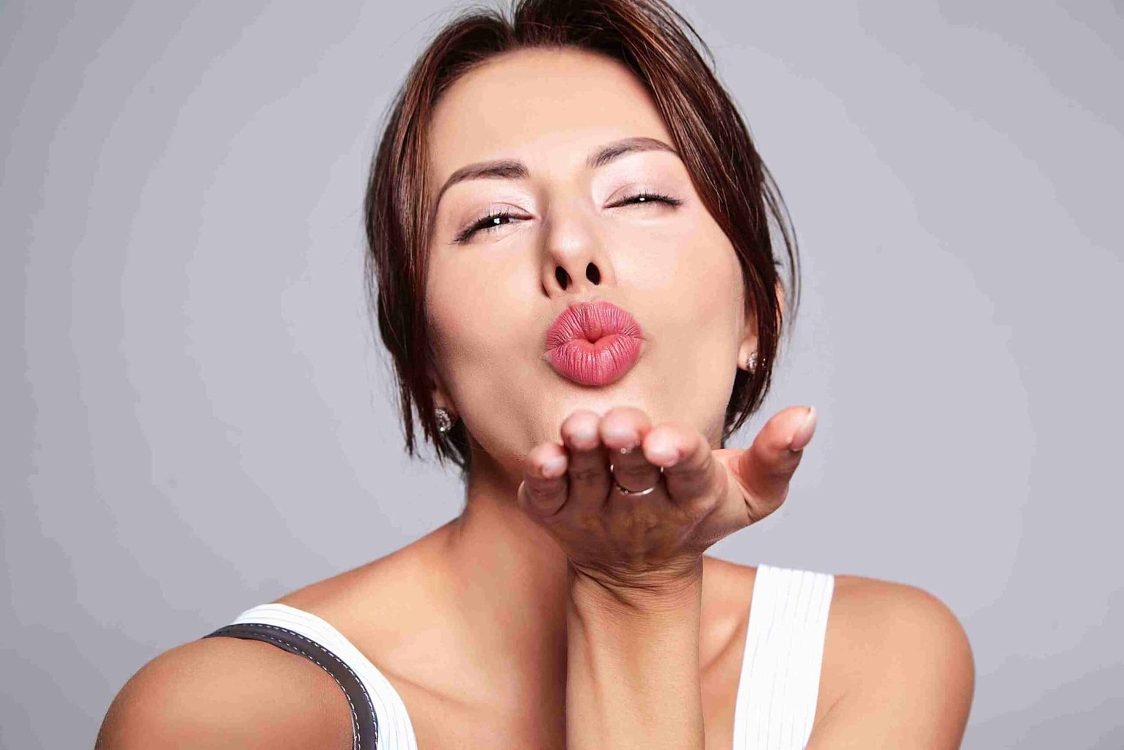 Woman showing sugar wax upper lip hair removal.