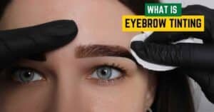 A close-up of a woman smiling with freshly tinted eyebrows